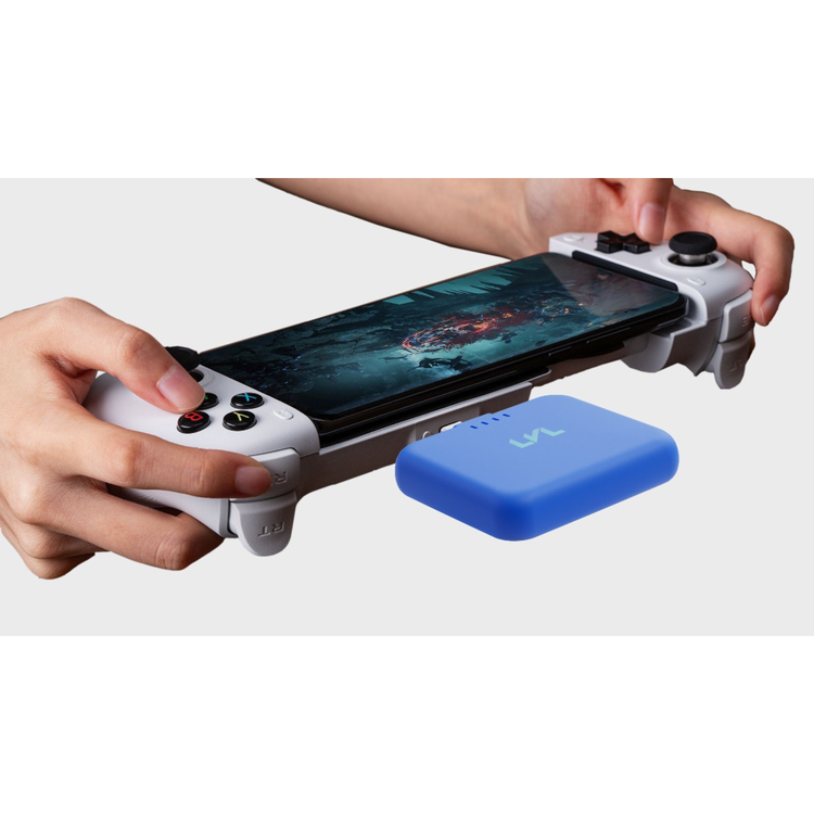 Hand holding a smartphone with a gaming controller attached, displaying a game on screen, with a blue device in front.