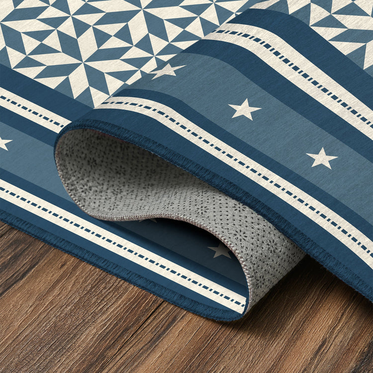 Blue and white patterned rug on a wooden floor