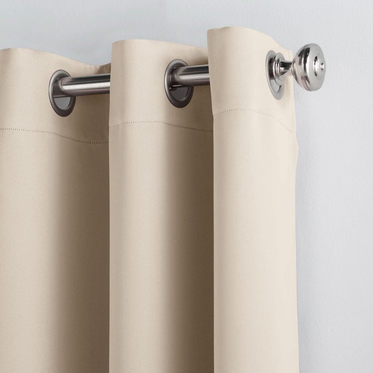 Beige curtains with silver rings on a gray background