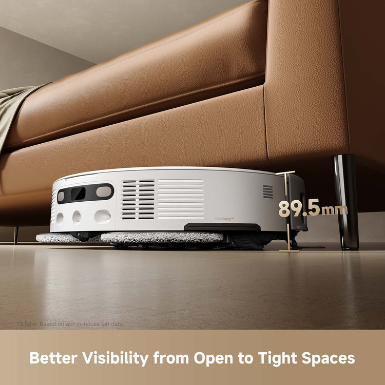 Robotic vacuum cleaner under a brown sofa with text indicating its width.