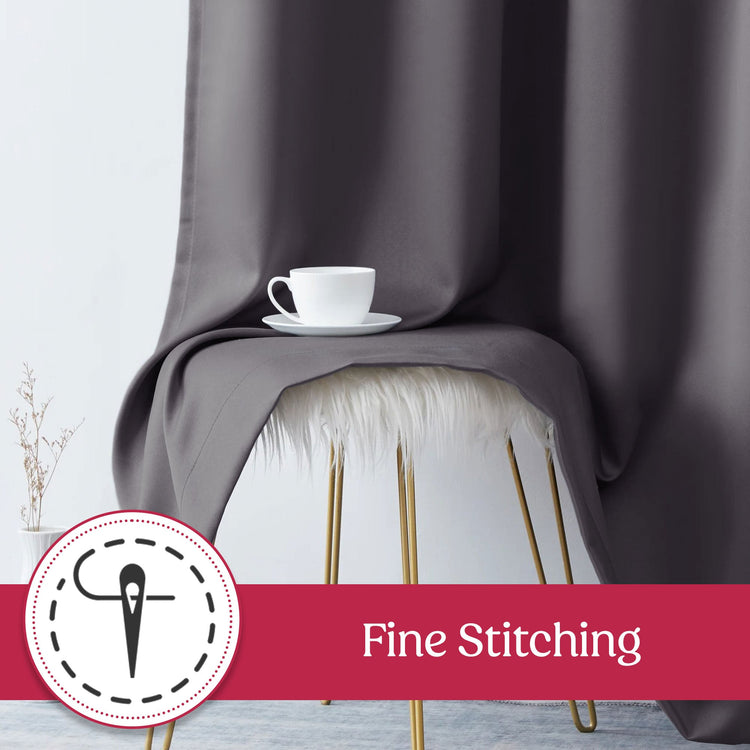 Dark gray curtain draped over a chair with a white cup on a saucer, featuring 'Fine Stitching' label.