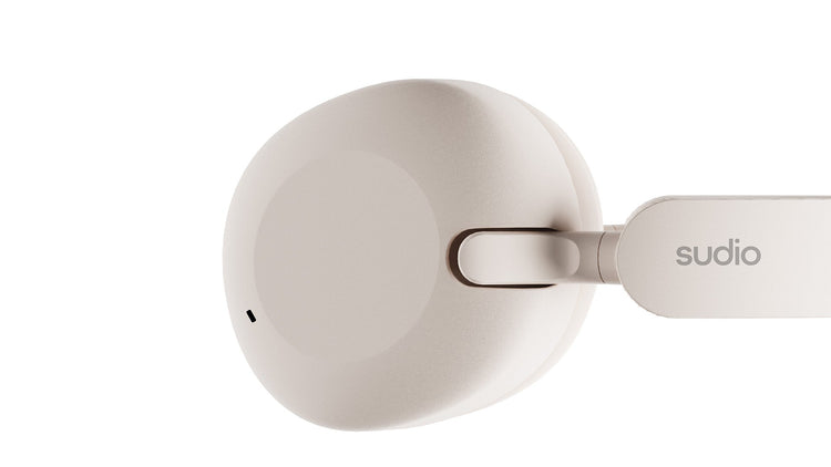 White earbud with 'sudio' branding on a white background