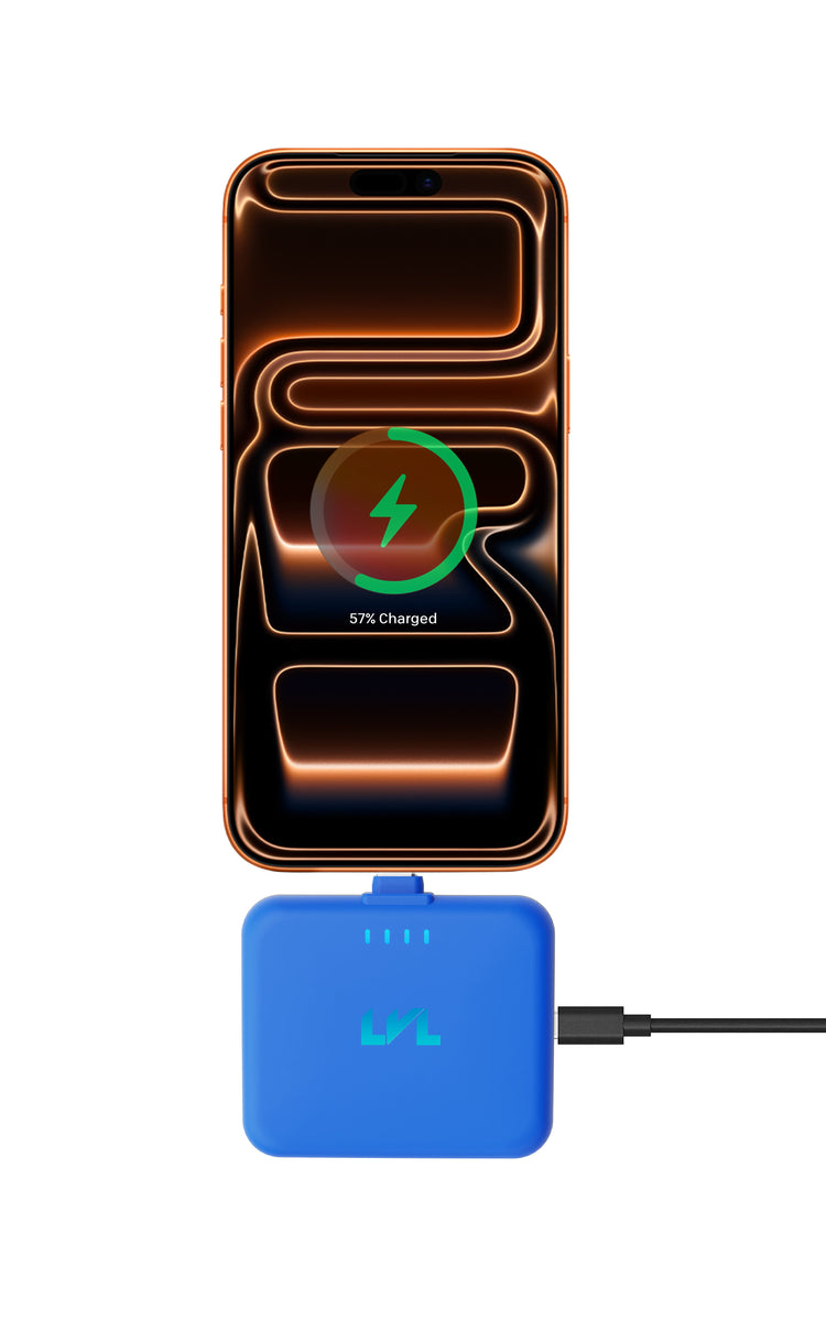 Smartphone with a charging app icon on the screen, connected to a blue charging pad.