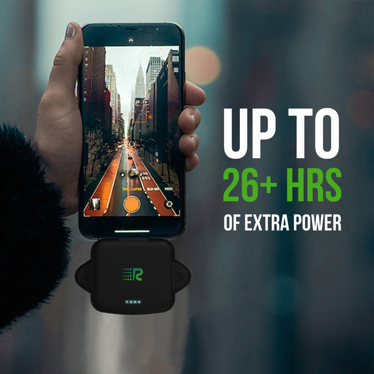 Hand holding a smartphone with a game displayed, charging pad below, and text about battery life.