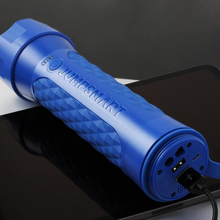 Blue JumpSmart device on a reflective surface with a dark background