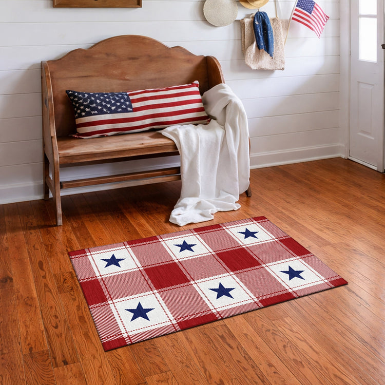 Wooden bench with American flag pillow and plaid rug on wooden floor