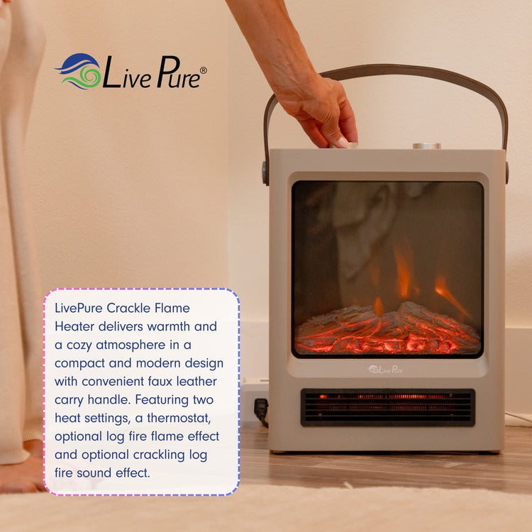 LivePure crackle flame heater with a hand holding it, displaying warm glow inside.