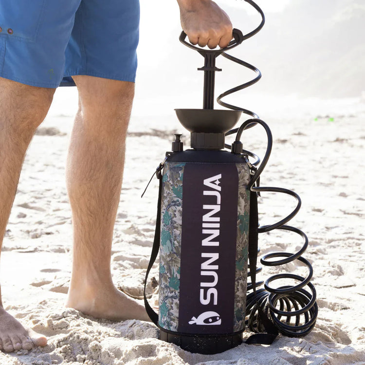 Person holding a SunNinja product on a sandy surface