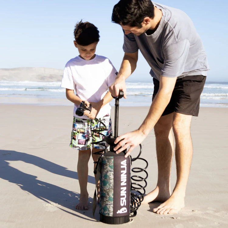 Man and child on a beach with a SunNinja product