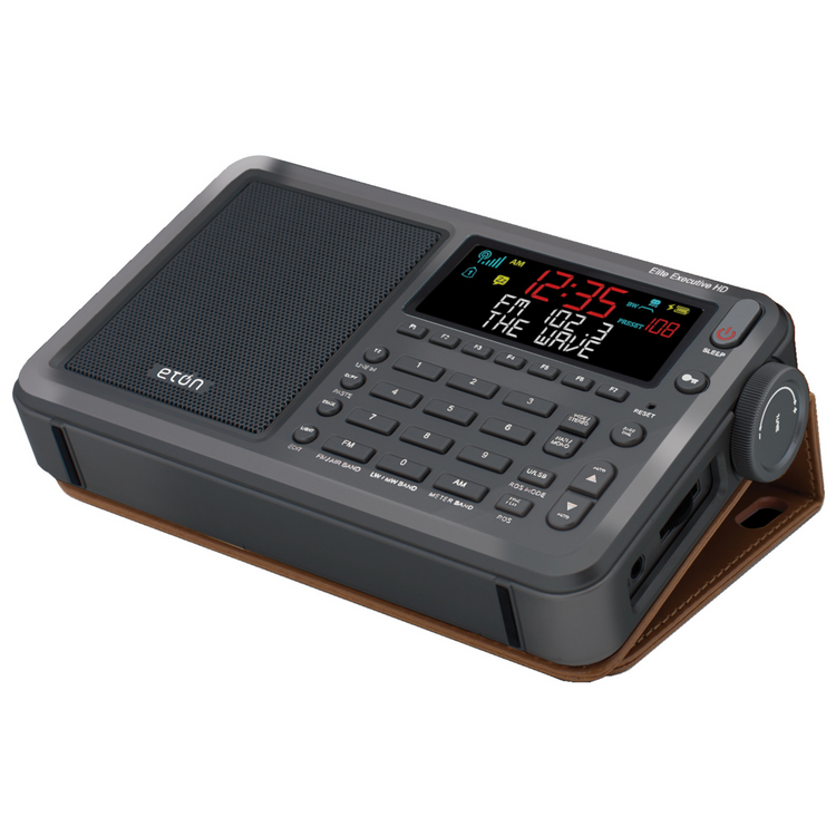 Gray digital clock radio with wooden stand on a white background