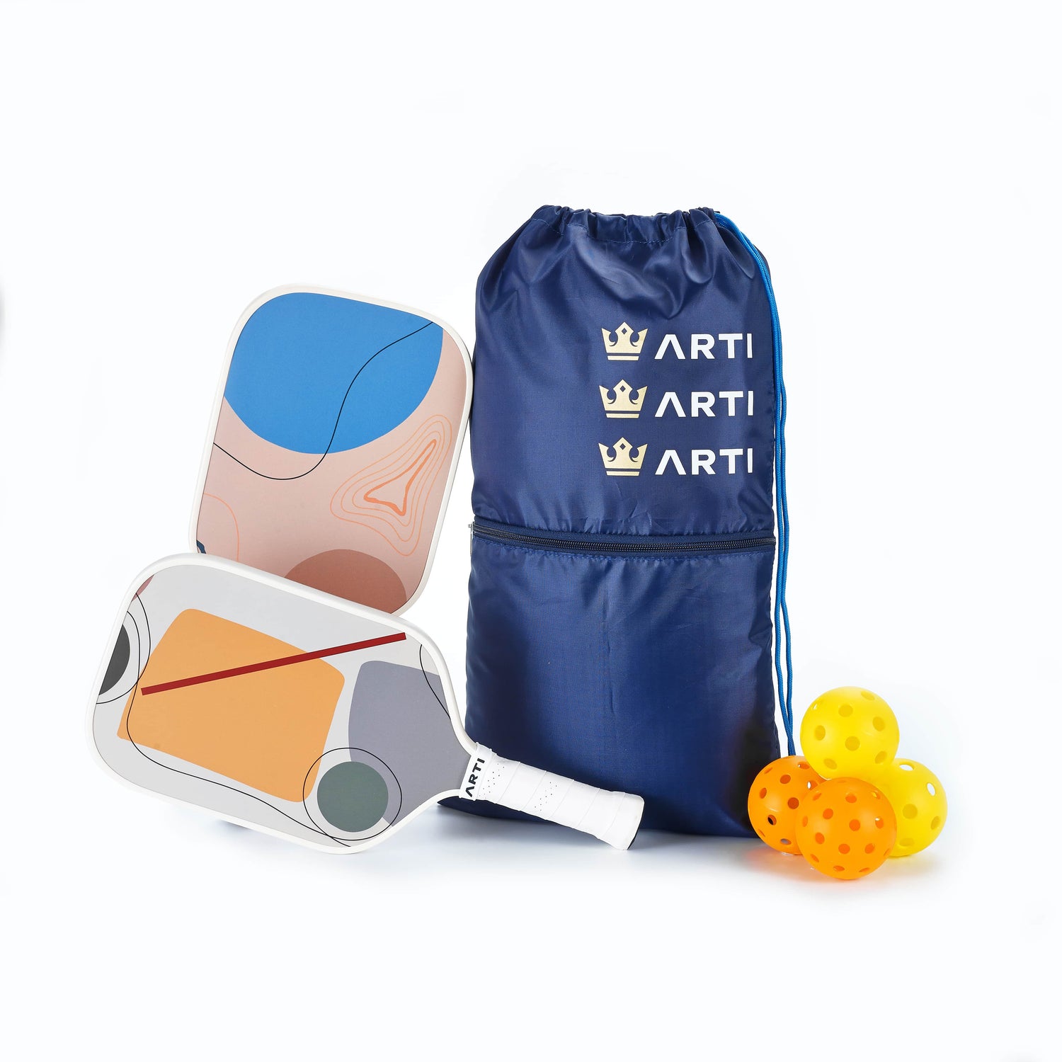 Two pickleball paddles, a blue drawstring bag with 'ART!' branding, and three pickleballs on a white background.