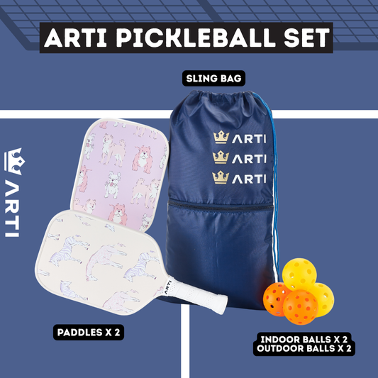 Pickleball paddles with colorful designs, a blue drawstring bag, and orange pickleballs on a white background.
