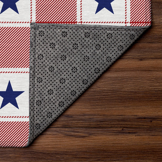 Wooden bench with American flag pillow and plaid rug on wooden floor