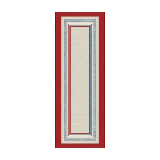 Wooden bench with striped cushions in a room with a red and white patterned rug.
