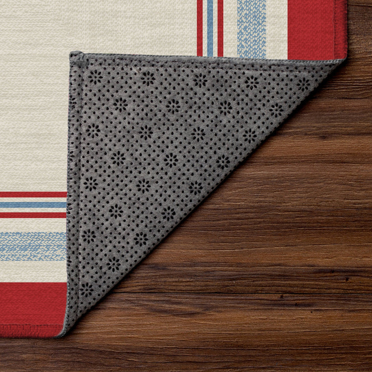 Kennedy bordered washable area rug with red and blue stripe frame on ivory base designed for living rooms, bedrooms, and hallways with non slip backing.