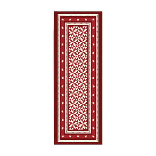 Decorative red and white patterned rug on a wooden floor in a kitchen.