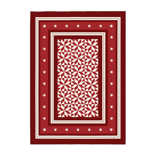 Decorative red and white patterned rug on a wooden floor in a kitchen.