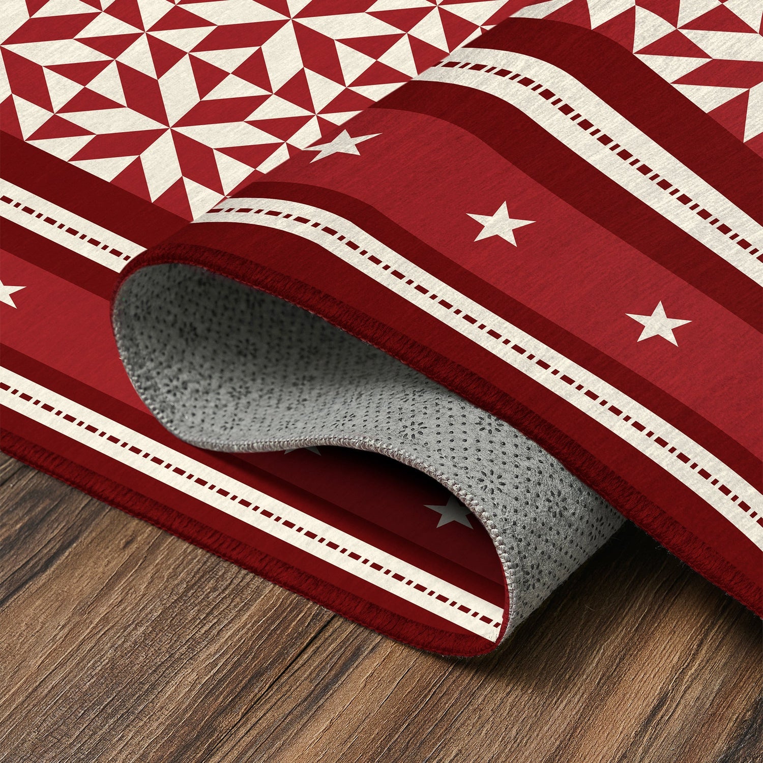 Red and white patterned rug on a wooden floor