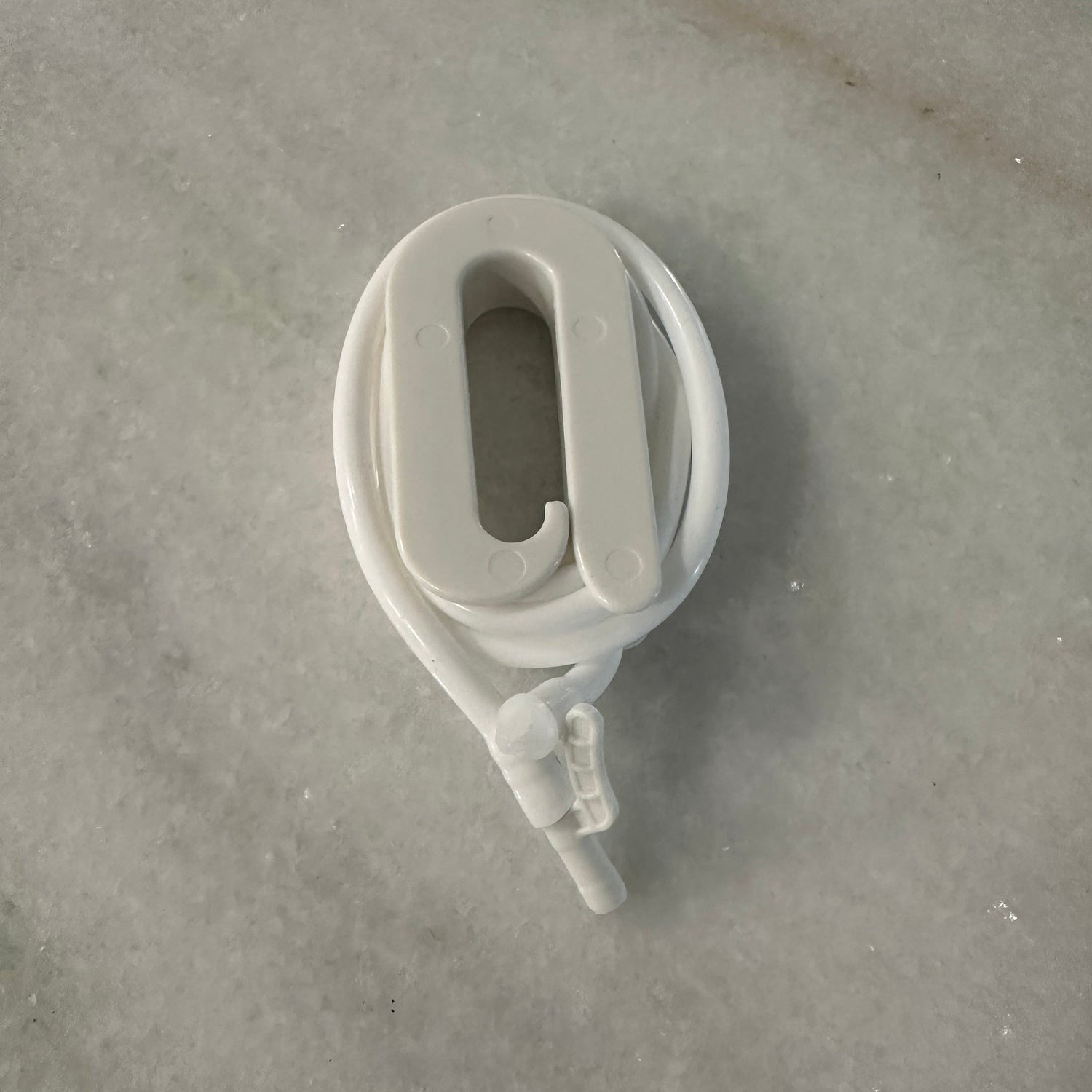 White plastic pulley system on a gray concrete surface
