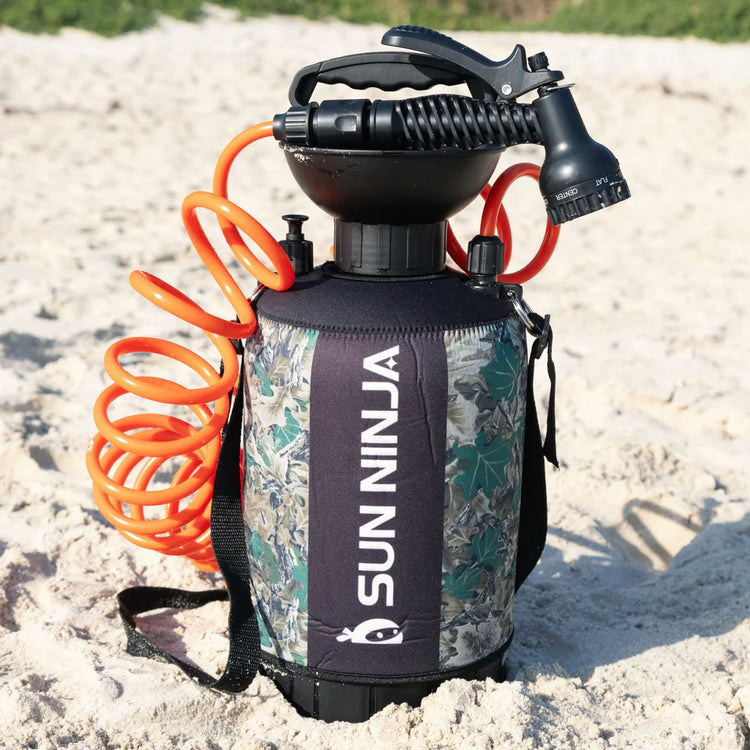 Sun Ninja spray bottle with camouflage design on a sandy background