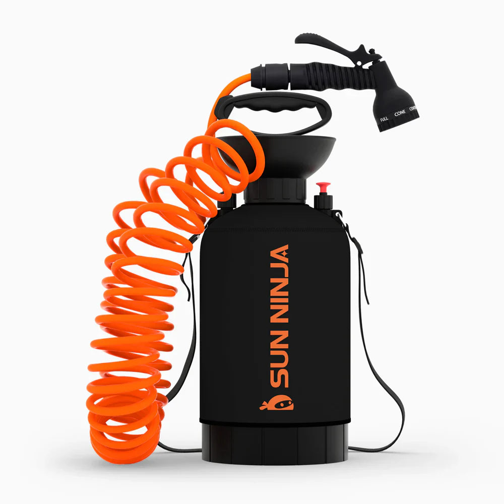 Black and orange spray bottle with coiled hose on a white background