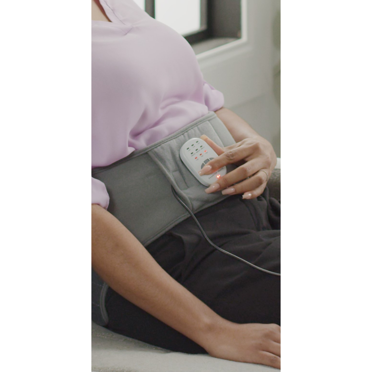 Person using a waist massager with a remote control