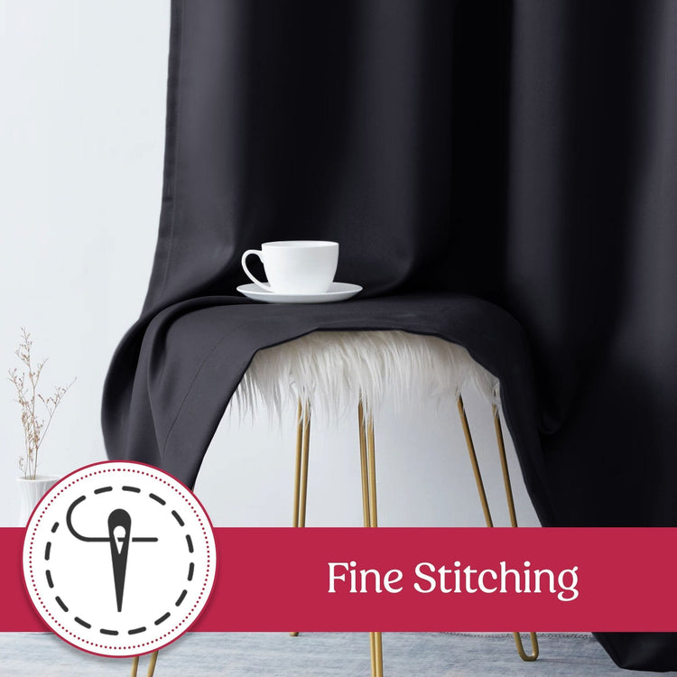 Black fabric draped over a white stool with a white cup on a saucer, labeled 'Fine Stitching'.
