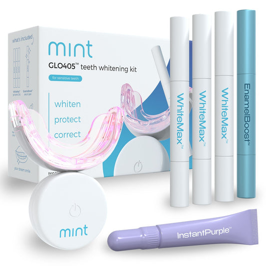 Teeth whitening kit with packaging and various whitening products on a white background