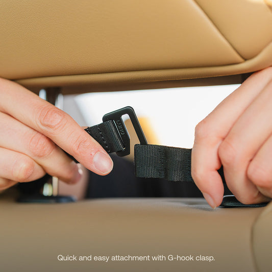 The Luno® Seatback Organizer, a vehicle essential in gray fabric, easily attaches to the back of a beige car seat and features multiple pockets, including mesh and zippered compartments—ideal for car camping adventures.
