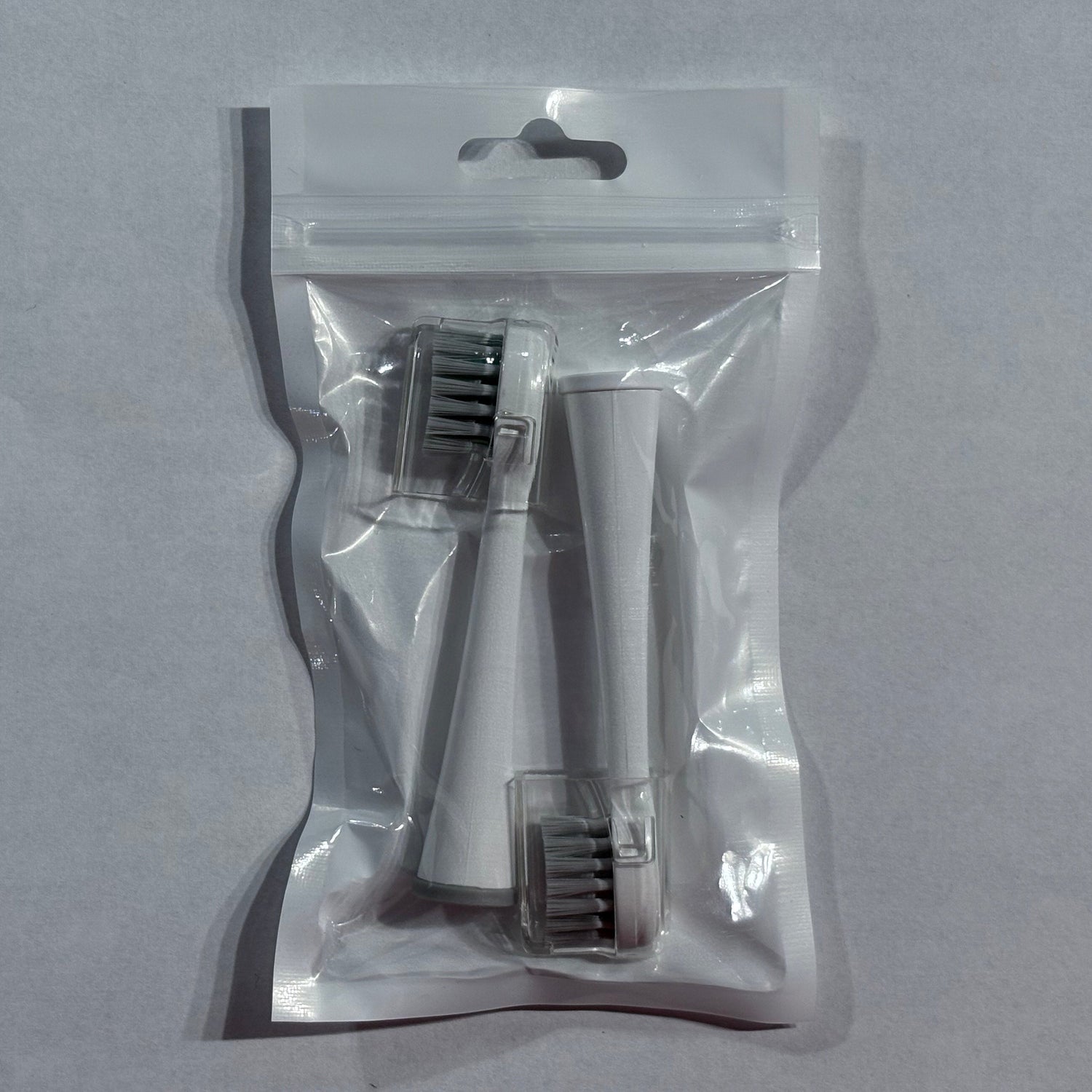 Clear plastic packaging with dental tools on a gray background