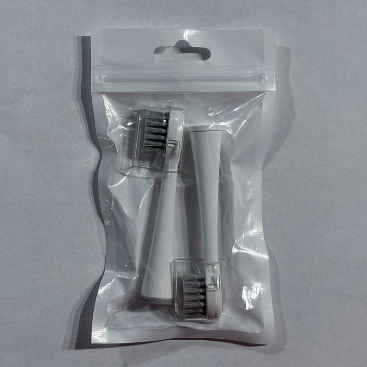 Clear plastic packaging with dental tools on a gray background
