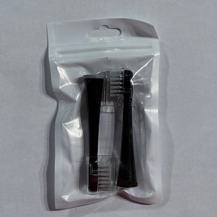 Two black hairbrushes in a clear plastic packaging on a gray background