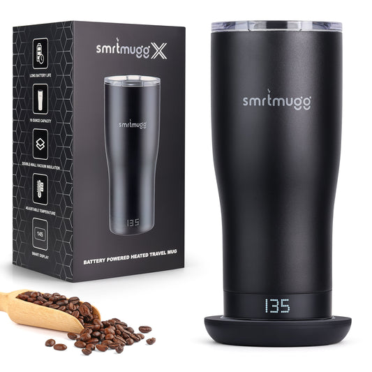 Black heated travel mug with digital display and packaging, surrounded by coffee beans and a scoop.