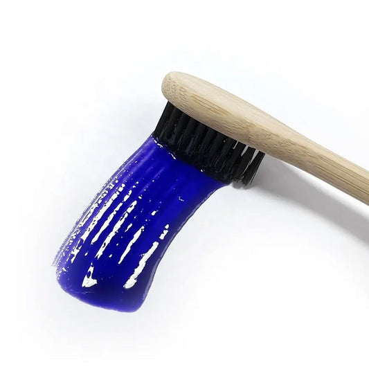 A product image showing a box and tube of Mint InstantPurple Color Corrector with nHAp. The packaging is primarily purple and white with text detailing the product's benefits and instructions for use.