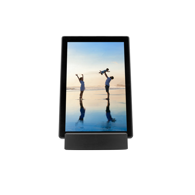 Digital photo frame displaying an image of two people on a beach.
