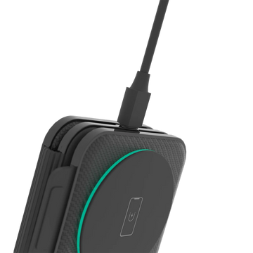 Black wireless charging pad with a USB cable on a white background