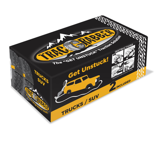 Two tires with snow chains and a green carrying bag on a white background