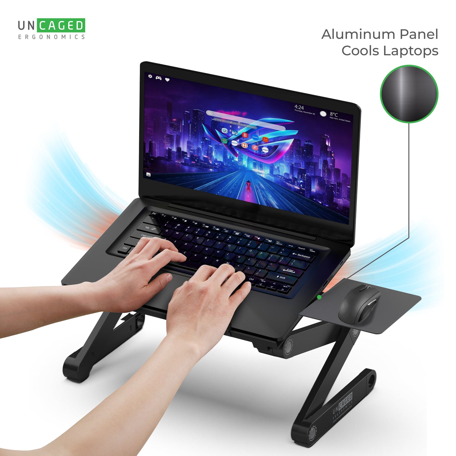 Laptop on a cooling stand with hands typing, featuring 'UNCAGED' branding.