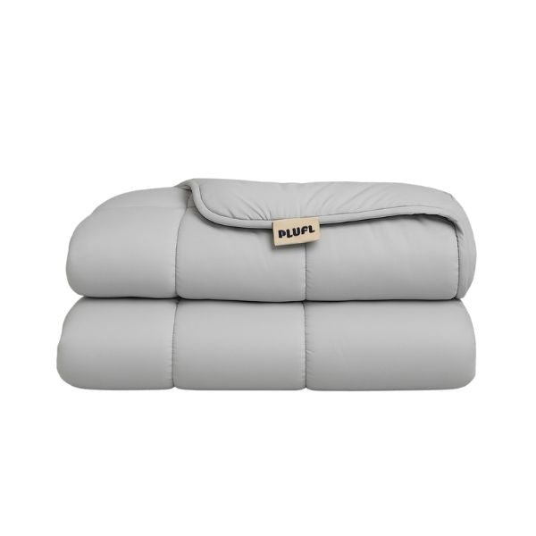 Folded gray weighted blanket with 'PLUFL' label on a white background