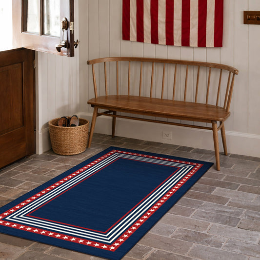 Navy blue rug with red and white border in front of a wooden bench and American flag.