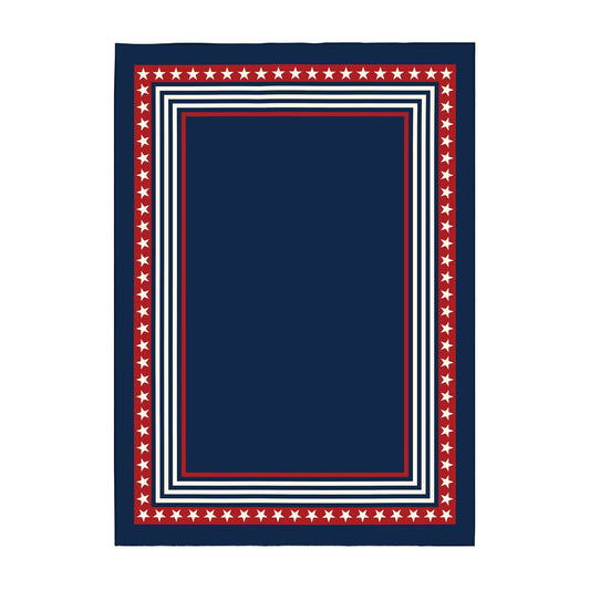 Navy blue rug with red and white border in front of a wooden bench and American flag.
