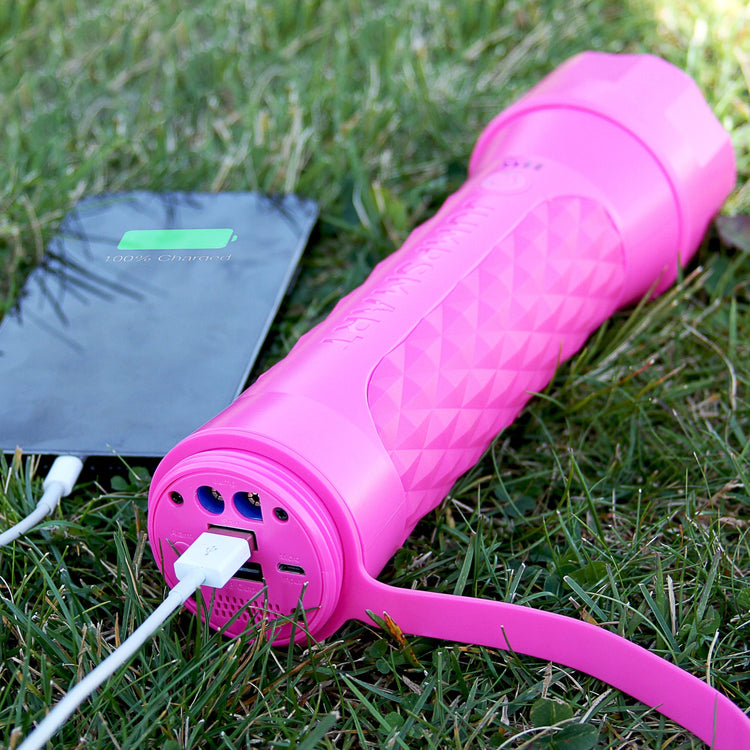 Pink jump rope with a power bank on grass