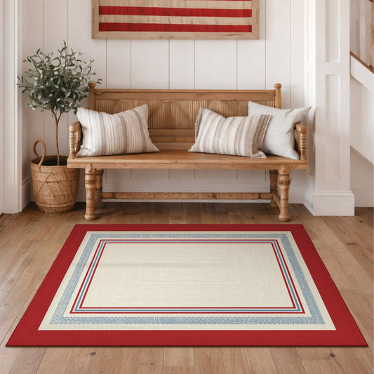Wooden bench with striped cushions in a room with a red and white patterned rug.