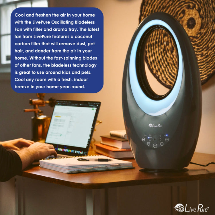 LivePure oscillating bladeless fan on a desk with a laptop, books, and decorative items.
