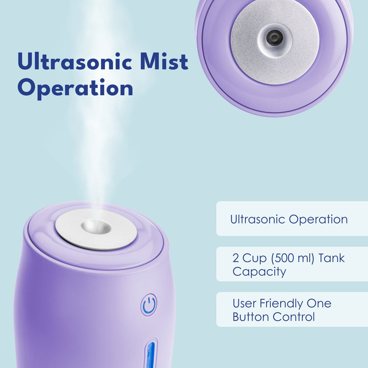 Purple ultrasonic humidifier with mist being emitted on a light blue background