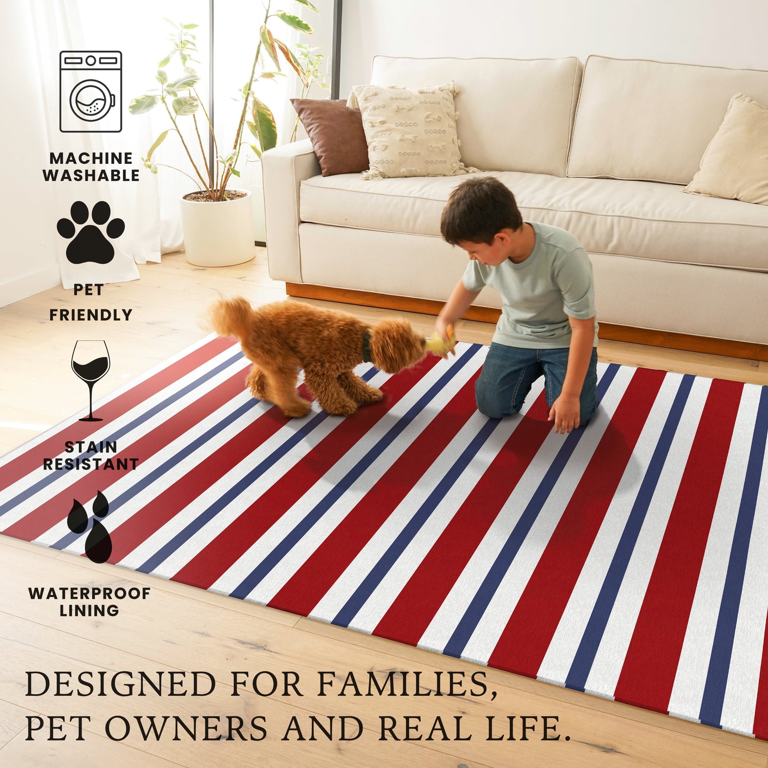 Child playing with a dog on a red, white, and blue striped rug in a living room.