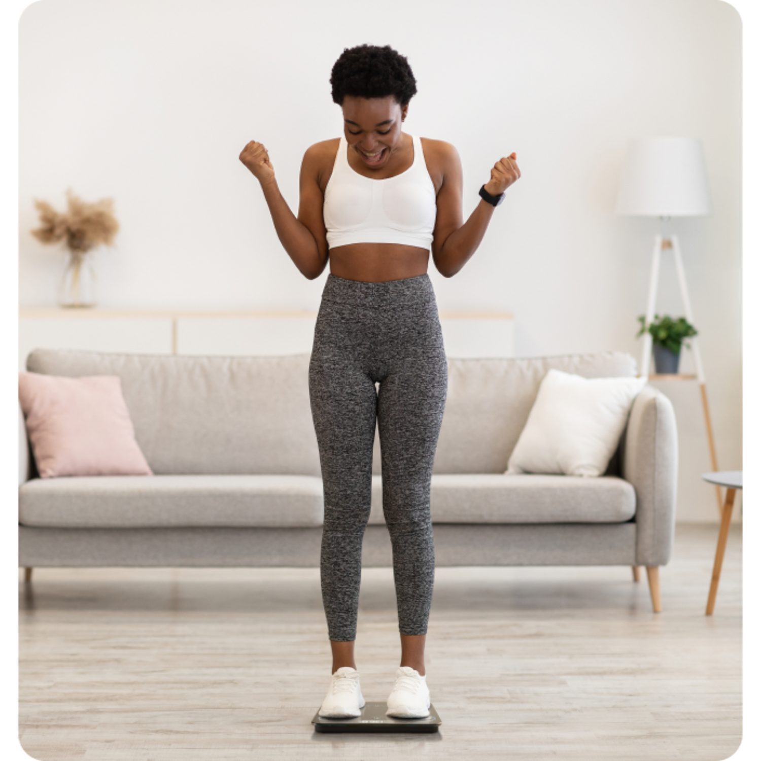 Woman exercising on a step platform in a living room.